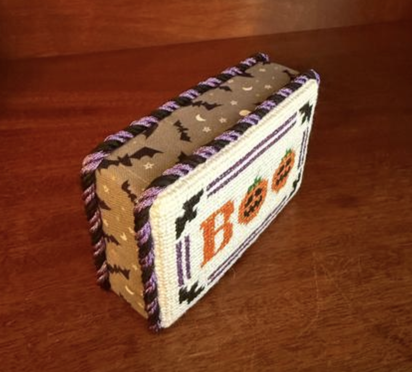 Side view showing the bat print and purple trim on the finished BOO needlepoint